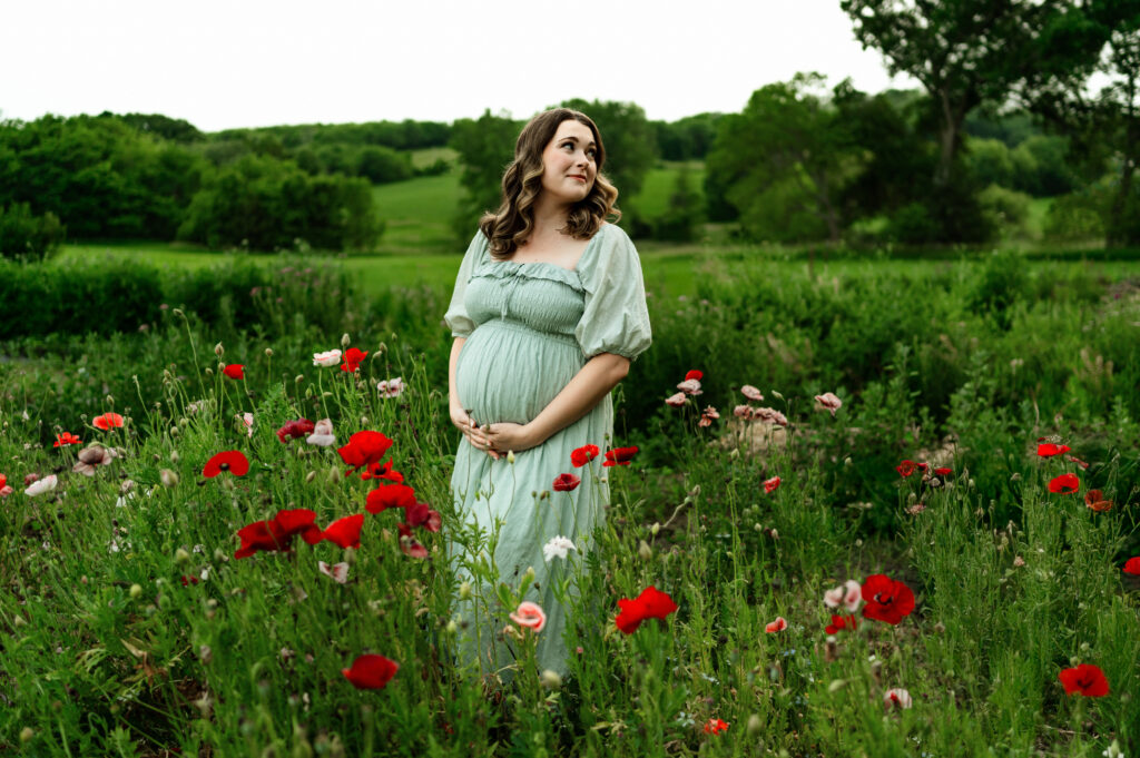 pregnant mom posed in fower field